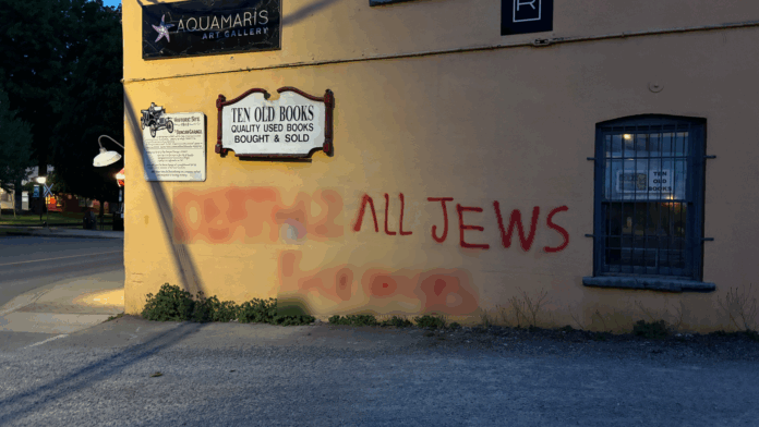 Blurred photo of spraypainted hate speech on a building in Duncan, B.C.
